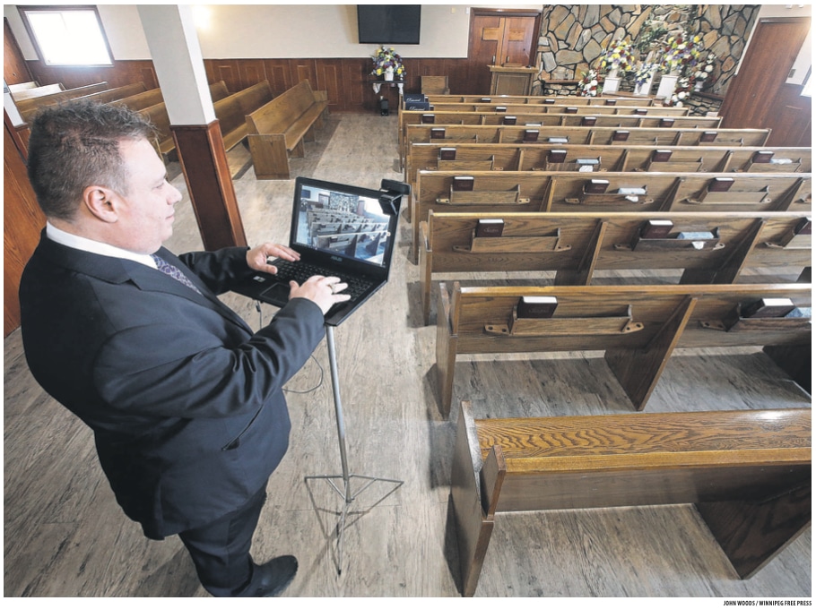 Mike Vogiatzakis, general manager of Voyage Funeral Home, sets up a computer for livestreaming Wednesday. Funeral homes are changing their practices in this time of social isolation.